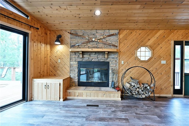 W7607 Whitetail Dr, Minong, WI 54859 - unfurnished living room featuring healthy amount of natural light, wood walls, wood finished floors, a fireplace, and wooden ceiling