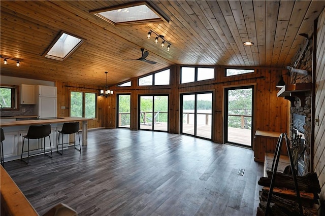 W7607 Whitetail Dr, Minong, WI 54859 - living area featuring a skylight, wooden ceiling, vaulted ceiling, healthy amount of natural light, and rail lighting