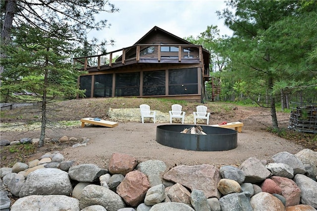 W7607 Whitetail Dr, Minong, WI 54859 - back of property with a sunroom and an outdoor fire pit