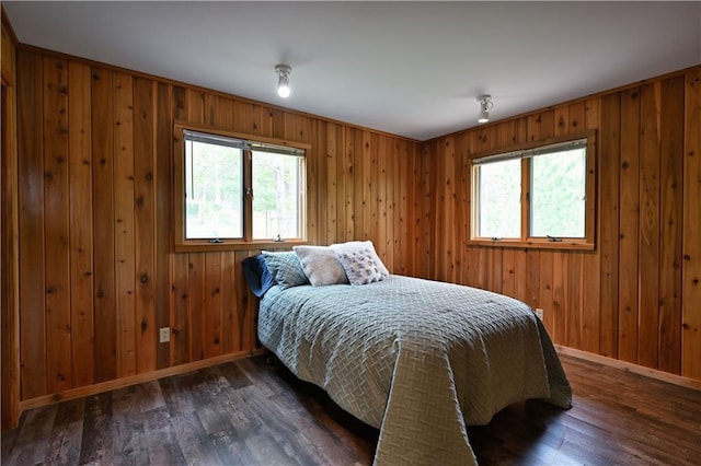 W7607 Whitetail Dr, Minong, WI 54859 - bedroom featuring baseboards, wood finished floors, and wooden walls