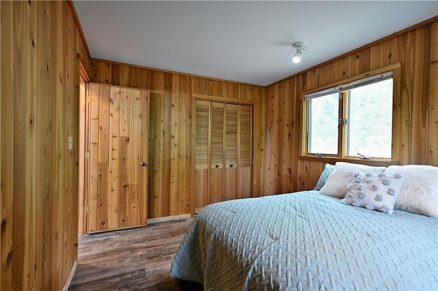 W7607 Whitetail Dr, Minong, WI 54859 - bedroom featuring dark wood-style flooring, wood walls, and a closet