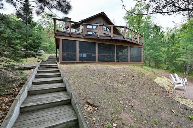 W7607 Whitetail Dr, Minong, WI 54859 - back of house with a sunroom, stairs, and a chimney