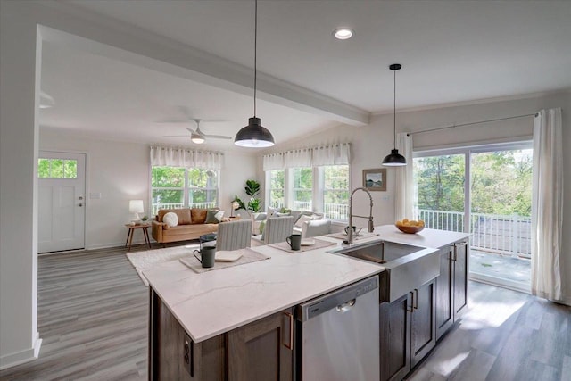 103 Lake Ct, Edgerton, WI 53534 - kitchen with stainless steel dishwasher, a sink, baseboards, light wood-style floors, and recessed lighting