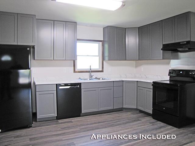 79 1st Ave, Benton, WI 53803 - kitchen with black appliances, gray cabinets, under cabinet range hood, and a sink