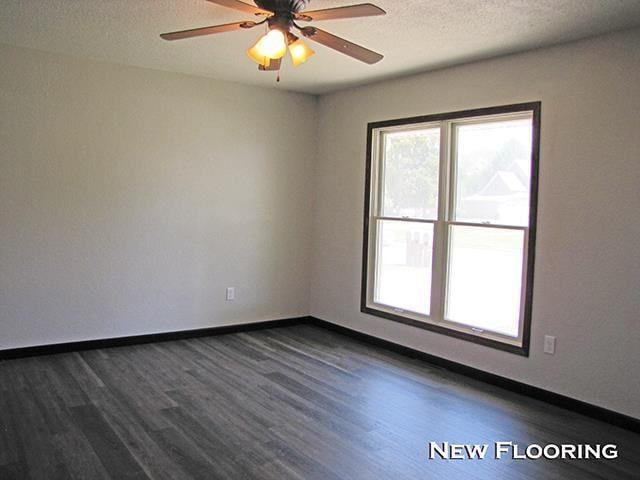 79 1st Ave, Benton, WI 53803 - spare room with dark wood-style floors, ceiling fan, baseboards, and a textured ceiling