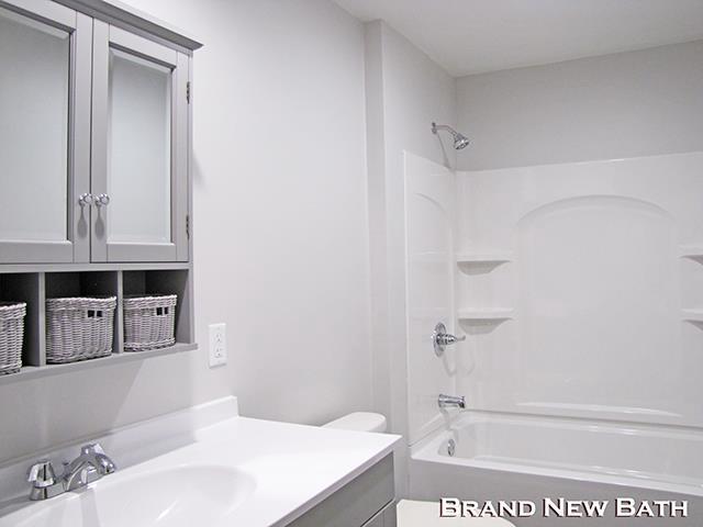 79 1st Ave, Benton, WI 53803 - full bath featuring vanity,  shower combination, and toilet