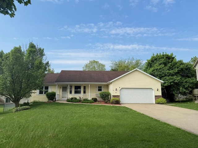 407 Overlook Ter, Marshall, WI 53559 - single story home featuring covered porch, a garage, concrete driveway, and a front lawn