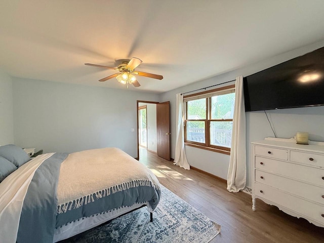 407 Overlook Ter, Marshall, WI 53559 - bedroom with light wood-style floors, a ceiling fan, and baseboards