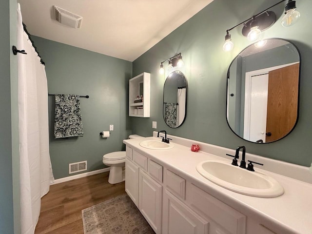 407 Overlook Ter, Marshall, WI 53559 - full bathroom with wood finished floors, toilet, double vanity, and baseboards