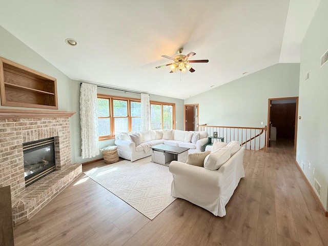 407 Overlook Ter, Marshall, WI 53559 - living area with lofted ceiling, a ceiling fan, wood finished floors, and a fireplace