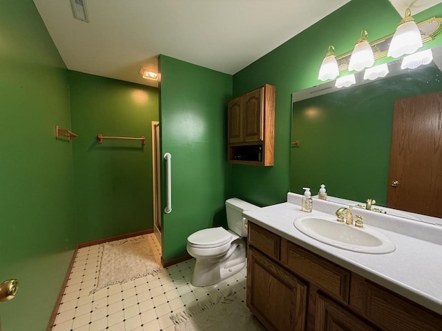 407 Overlook Ter, Marshall, WI 53559 - bathroom featuring toilet, tile patterned floors, a stall shower, vanity, and baseboards