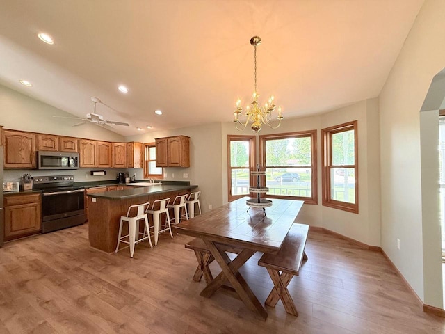 407 Overlook Ter, Marshall, WI 53559 - dining space featuring recessed lighting, a chandelier, light wood-style floors, lofted ceiling, and ceiling fan