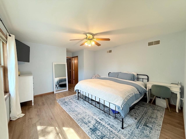 407 Overlook Ter, Marshall, WI 53559 - bedroom with light wood-style flooring, a ceiling fan, and baseboards