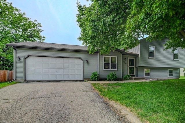 906 Spahn Dr, Waunakee, WI 53597 - tri-level home featuring driveway and a garage
