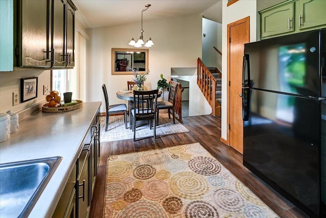 906 Spahn Dr, Waunakee, WI 53597 - kitchen featuring freestanding refrigerator, a chandelier, green cabinets, dark wood-type flooring, and a sink