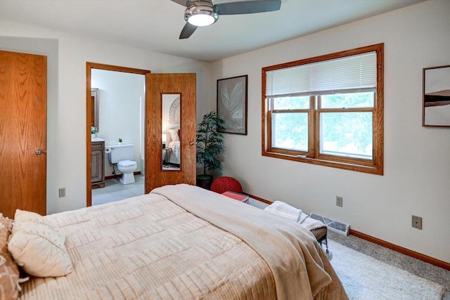 906 Spahn Dr, Waunakee, WI 53597 - bedroom featuring baseboards, connected bathroom, and a ceiling fan