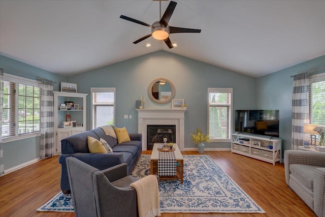 2330 Mica Rd, Madison, WI 53719 - living room featuring a ceiling fan, a fireplace, healthy amount of natural light, wood finished floors, and vaulted ceiling