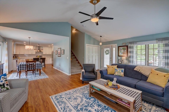 2330 Mica Rd, Madison, WI 53719 - living room featuring light wood-style floors, stairs, a ceiling fan, baseboards, and high vaulted ceiling