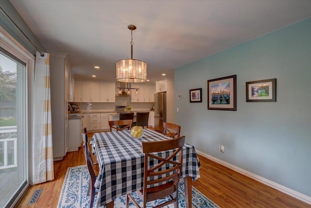 2330 Mica Rd, Madison, WI 53719 - dining area with light wood-style flooring, baseboards, a chandelier, and recessed lighting