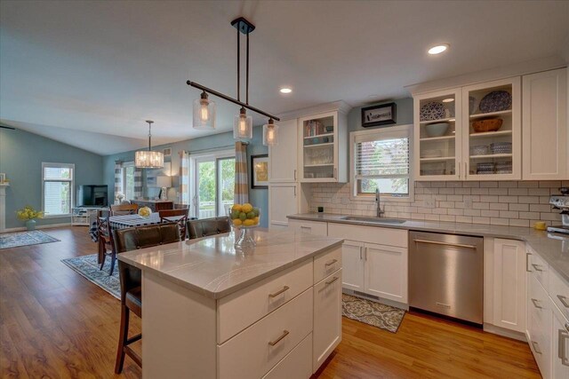 2330 Mica Rd, Madison, WI 53719 - kitchen with stainless steel dishwasher, a sink, tasteful backsplash, open floor plan, and lofted ceiling