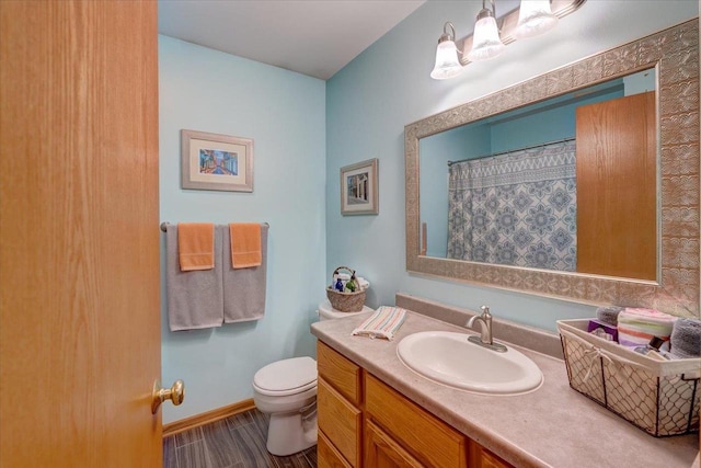2330 Mica Rd, Madison, WI 53719 - bathroom featuring toilet, vanity, wood finished floors, baseboards, and curtained shower