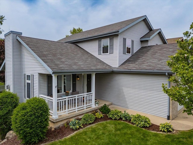 2330 Mica Rd, Madison, WI 53719 - traditional home with a porch, a chimney, a front yard, and roof with shingles