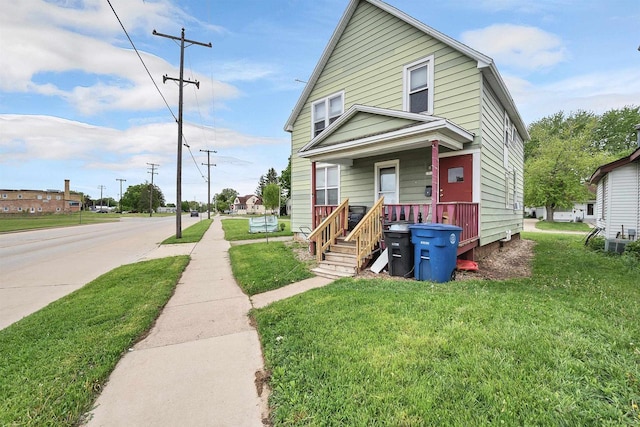 1515 Harrison St, Oshkosh, WI 54901 - view of front of property featuring covered porch and a front yard