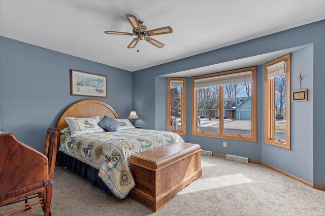 1502 Ridgewood Dr Unit D-7, West Bend, WI 53095 - carpeted bedroom with baseboards and ceiling fan