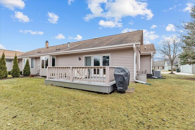 1502 Ridgewood Dr Unit D-7, West Bend, WI 53095 - back of property with central AC unit, a lawn, a wooden deck, and a shingled roof