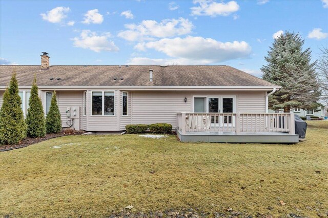 1502 Ridgewood Dr Unit D-7, West Bend, WI 53095 - back of property featuring a wooden deck, a yard, roof with shingles, and a chimney
