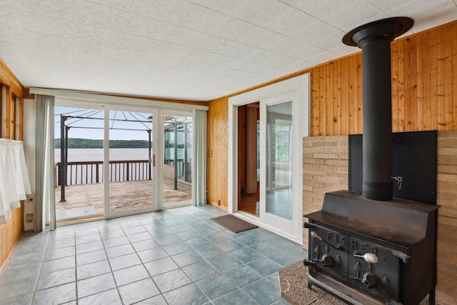 E14485 Baltic Ave, Merrimac, WI 53561 - living area with a wood stove, plenty of natural light, a water view, wood walls, and a sunroom