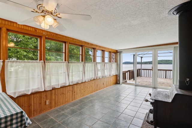 E14485 Baltic Ave, Merrimac, WI 53561 - sunroom with a water view, ceiling fan, wood walls, and tile patterned floors