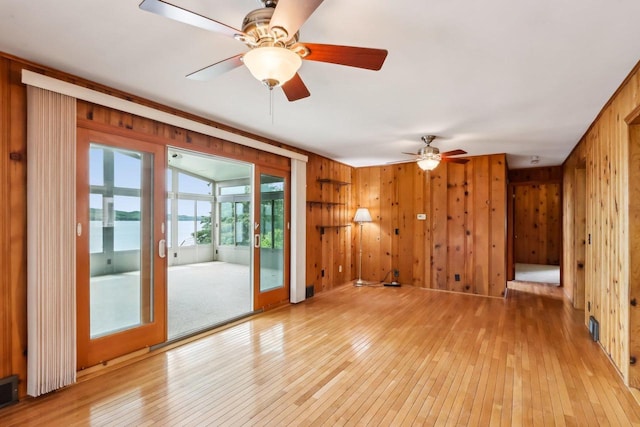 E14485 Baltic Ave, Merrimac, WI 53561 - unfurnished room featuring wooden walls, light wood-style flooring, and a ceiling fan