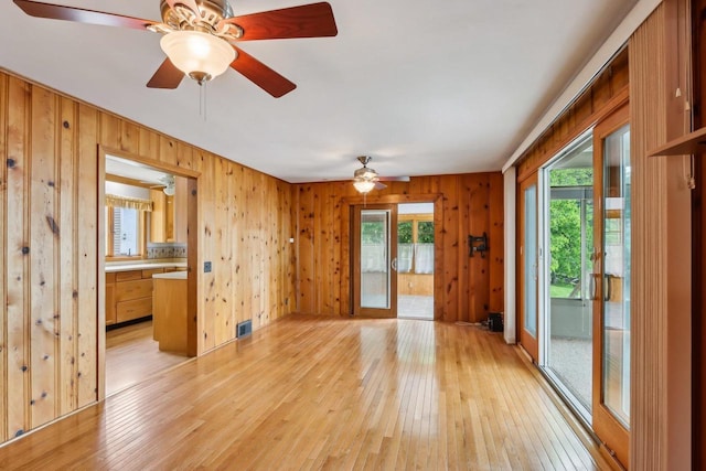 E14485 Baltic Ave, Merrimac, WI 53561 - spare room featuring healthy amount of natural light, light wood-style flooring, wood walls, and ceiling fan