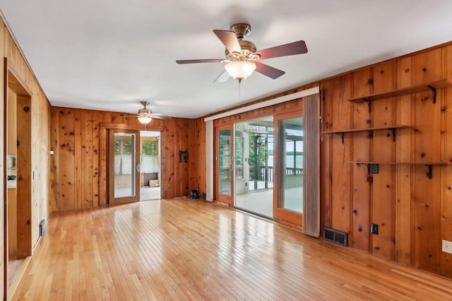 E14485 Baltic Ave, Merrimac, WI 53561 - unfurnished room featuring light wood finished floors, a ceiling fan, and wooden walls