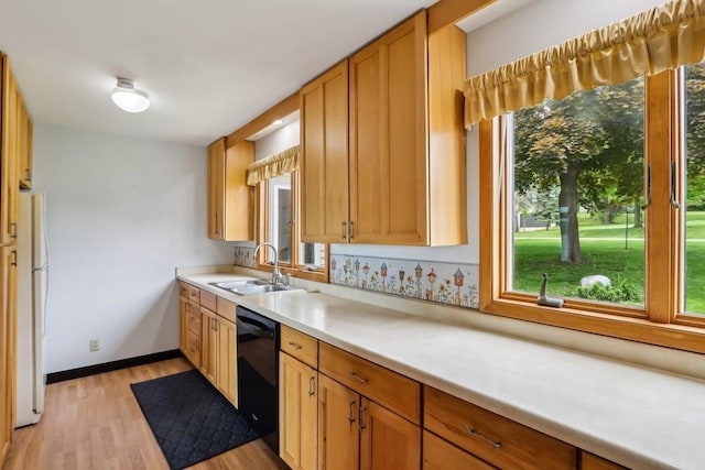 E14485 Baltic Ave, Merrimac, WI 53561 - kitchen with freestanding refrigerator, dishwasher, a sink, light wood finished floors, and light countertops