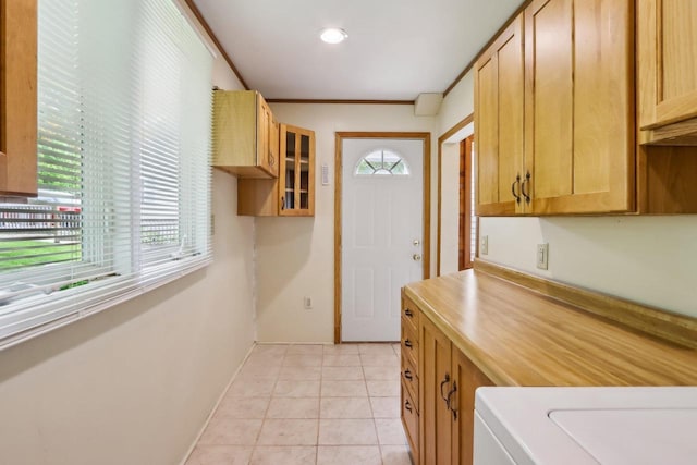 E14485 Baltic Ave, Merrimac, WI 53561 - kitchen featuring plenty of natural light, glass insert cabinets, light tile patterned flooring, light countertops, and ornamental molding