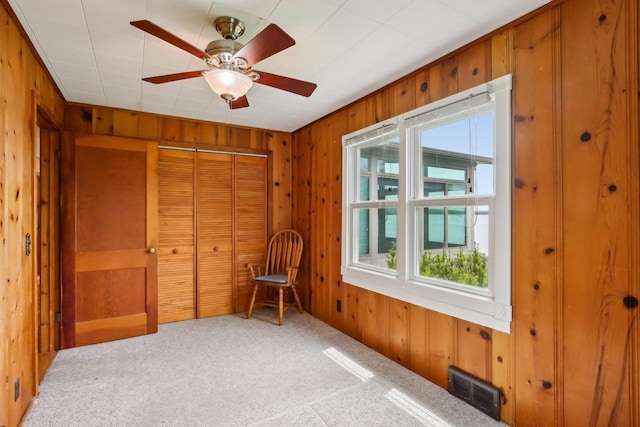 E14485 Baltic Ave, Merrimac, WI 53561 - unfurnished room with wood walls, carpet floors, and ceiling fan
