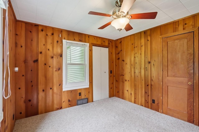E14485 Baltic Ave, Merrimac, WI 53561 - carpeted spare room with wooden walls and ceiling fan