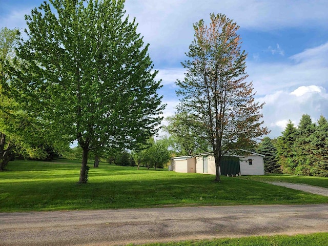 E14485 Baltic Ave, Merrimac, WI 53561 - view of green lawn with an outdoor structure, a detached garage, and driveway