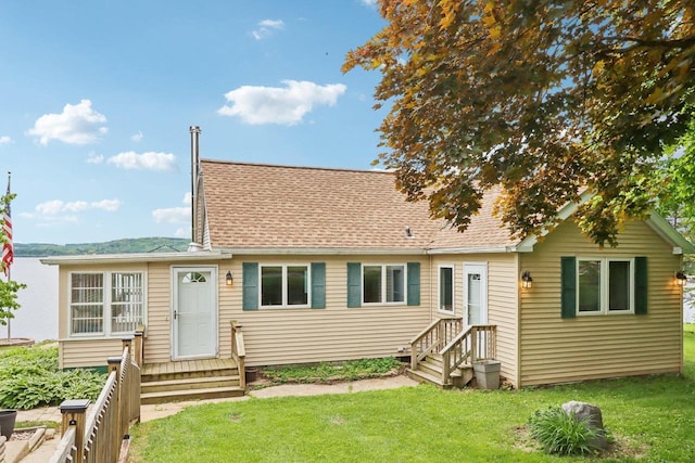 E14485 Baltic Ave, Merrimac, WI 53561 - rear view of house featuring entry steps, a lawn, and a shingled roof