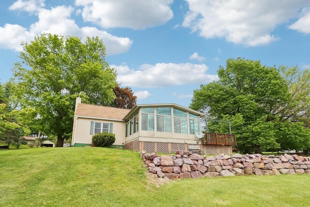 E14485 Baltic Ave, Merrimac, WI 53561 - rear view of house with a sunroom, a chimney, a lawn, and a deck