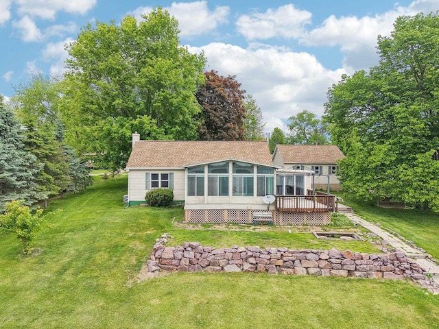 E14485 Baltic Ave, Merrimac, WI 53561 - back of house featuring a sunroom, a deck, a yard, and a chimney