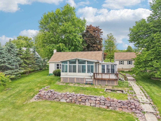 E14485 Baltic Ave, Merrimac, WI 53561 - back of property with a sunroom, a wooden deck, a lawn, and a chimney
