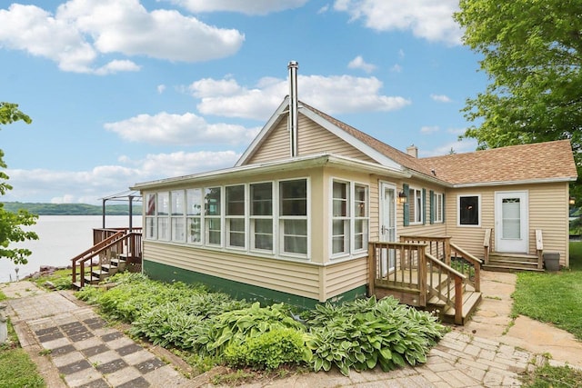 E14485 Baltic Ave, Merrimac, WI 53561 - rear view of house featuring stairs, entry steps, a water view, a sunroom, and a chimney
