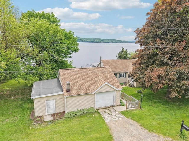 E14485 Baltic Ave, Merrimac, WI 53561 - view of front of house featuring driveway, a water view, and a garage