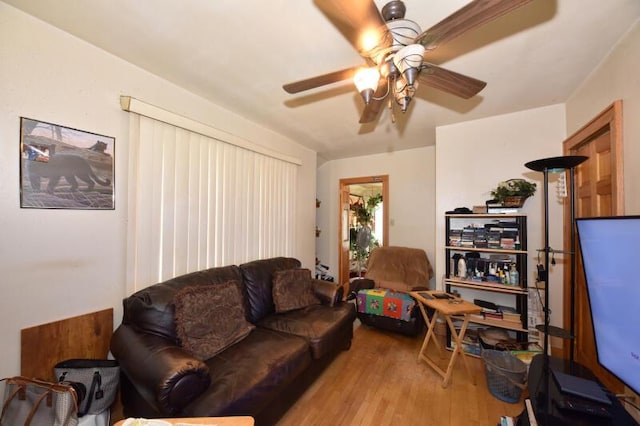 living area featuring wood finished floors and ceiling fan
