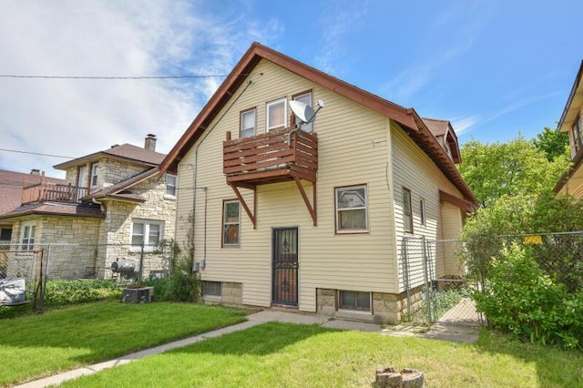 rear view of house with a balcony and a gate