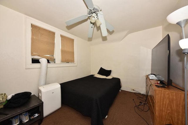 bedroom with lofted ceiling, a ceiling fan, and carpet flooring