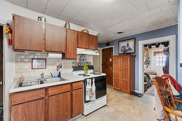 4084 Eagle Mound Pass, Deforest, WI 53532 - kitchen featuring electric range, a sink, under cabinet range hood, light countertops, and brown cabinetry